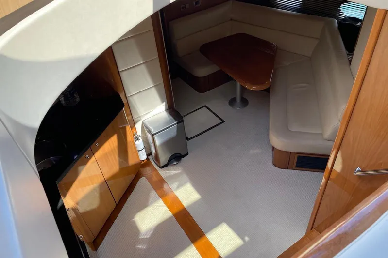 Relentless Yacht Photos Pics Interior of 2009 Sunseeker Predator 62 yacht with cozy seating and wooden finishes.