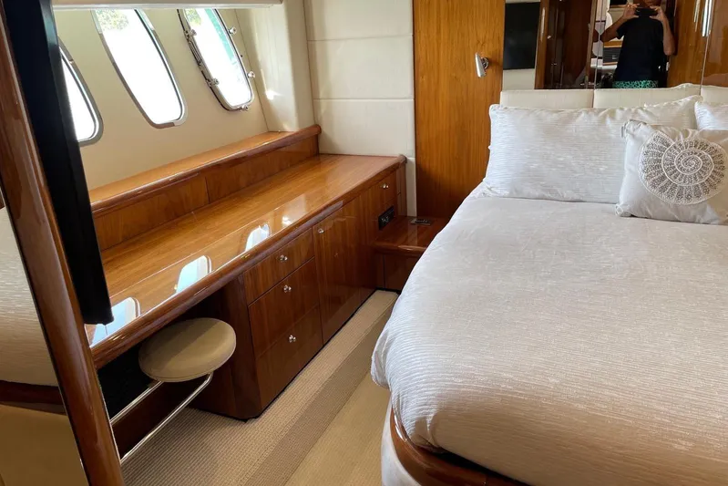 Relentless Yacht Photos Pics Luxurious bedroom interior of 2009 Sunseeker Predator 62 yacht with elegant wood finishes.