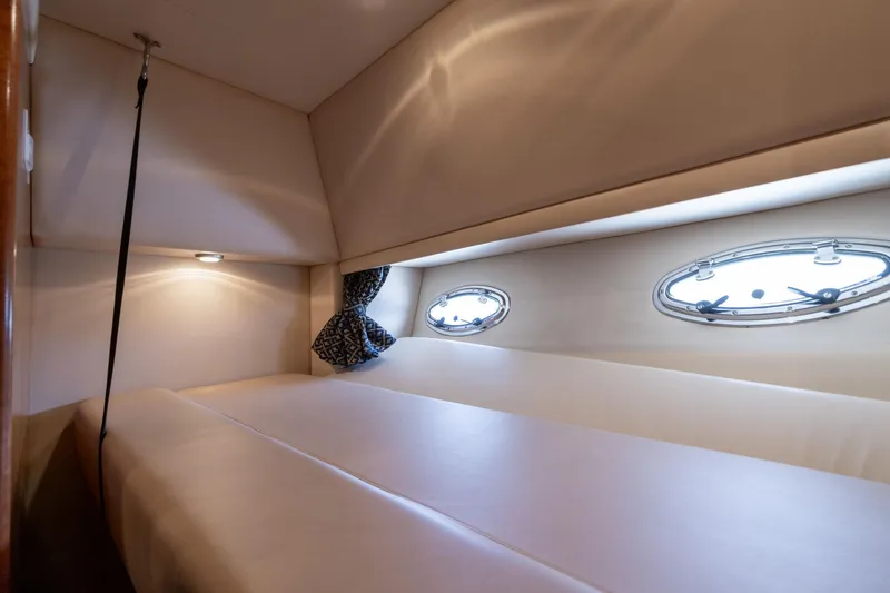 Candykiss Yacht Photos Pics 2003 Meridian 490 Pilothouse cabin interior with portholes and cozy bedding.
