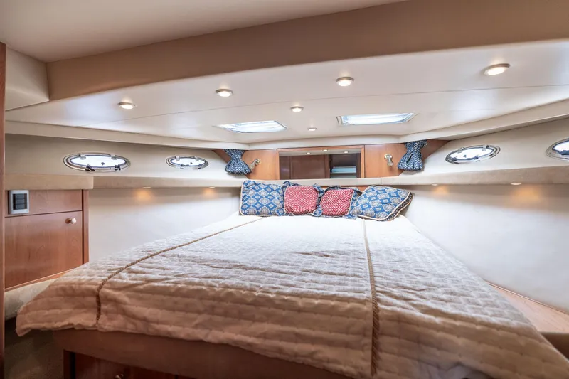 Candykiss Yacht Photos Pics Luxurious 2003 Meridian 490 Pilothouse bedroom with cozy bedding and elegant lighting.