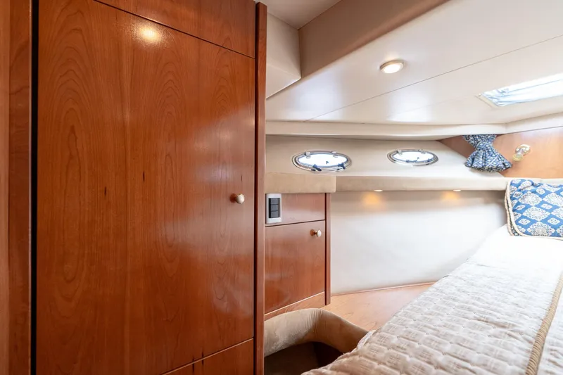 Candykiss Yacht Photos Pics Luxurious cabin interior of 2003 Meridian 490 Pilothouse yacht with wood finish and portholes.