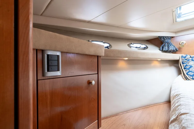 Candykiss Yacht Photos Pics Interior of 2003 Meridian 490 Pilothouse, featuring wood cabinetry and cozy sleeping area.