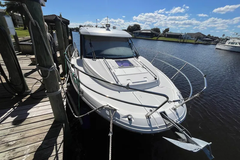 Iffin Yacht Photos Pics 2018 Jeanneau NC 895 boat docked on a sunny day, calm waters, clear sky.