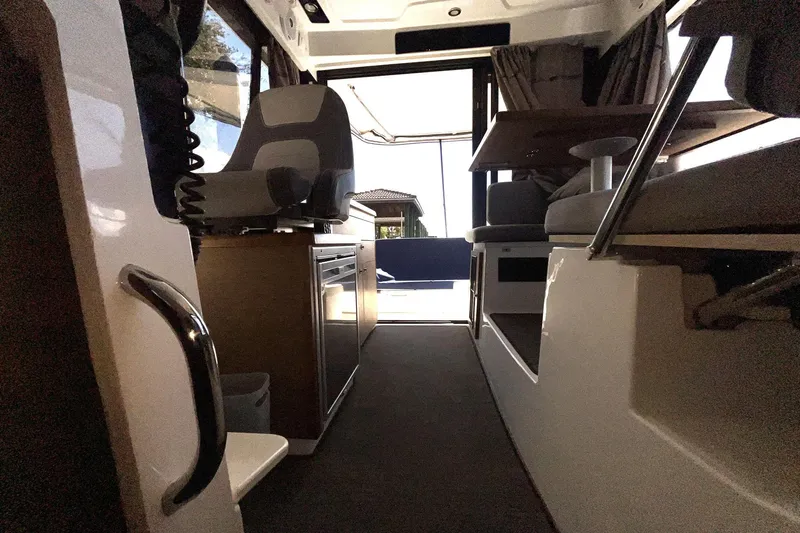 Iffin Yacht Photos Pics Interior view of 2018 Jeanneau NC 895 boat, featuring seating and helm area.