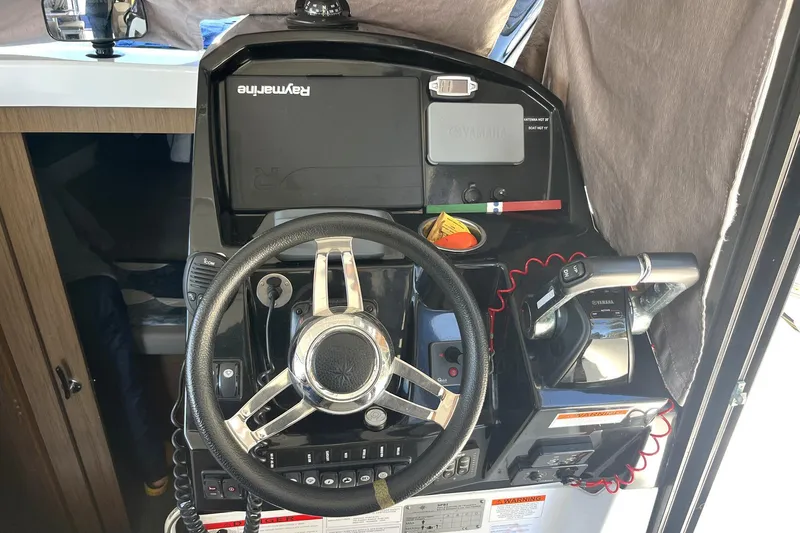 Iffin Yacht Photos Pics 2018 Jeanneau NC 895 helm with steering wheel and navigation controls.