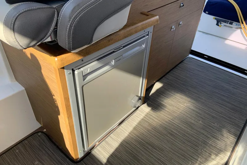 Iffin Yacht Photos Pics Interior of 2018 Jeanneau NC 895 boat with compact fridge and seating.