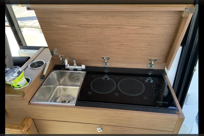 Iffin Yacht Photos Pics 2018 Jeanneau NC 895 kitchen with sink and Kenyon electric cooktop.