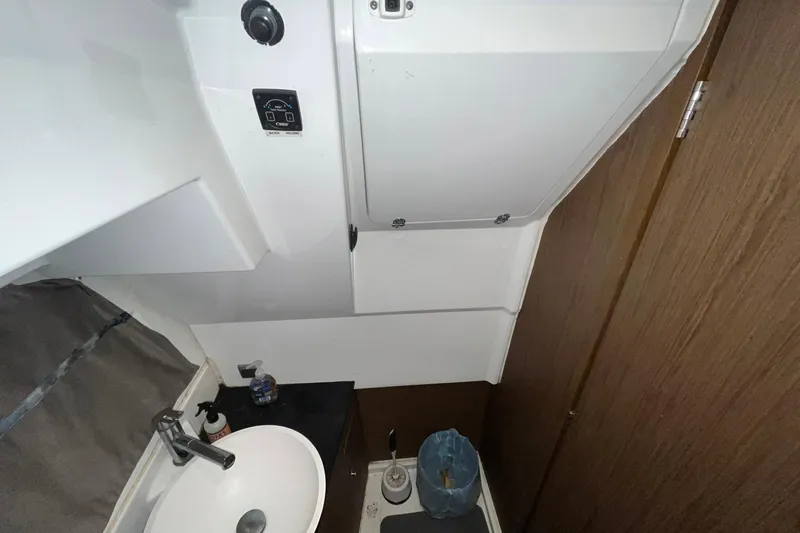 Iffin Yacht Photos Pics 2018 Jeanneau NC 895 boat bathroom interior with sink and storage.