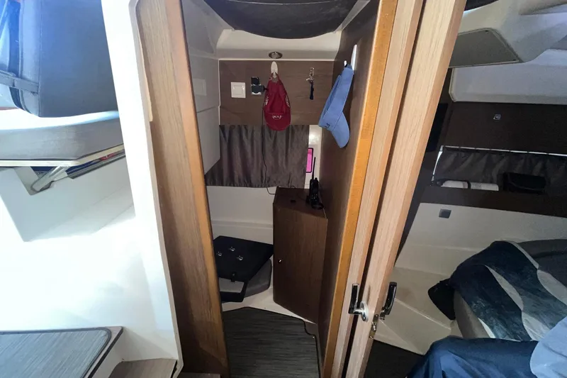 Iffin Yacht Photos Pics Interior cabin of 2018 Jeanneau NC 895 boat, featuring cozy sleeping area and storage.
