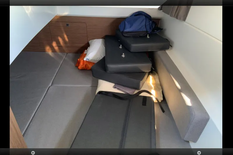 Iffin Yacht Photos Pics Interior cabin of 2018 Jeanneau NC 895 with cushions and bags.