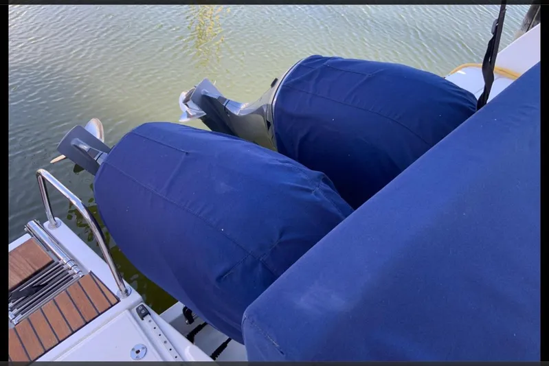 Iffin Yacht Photos Pics 2018 Jeanneau NC 895 boat with covered outboard motors on calm water.