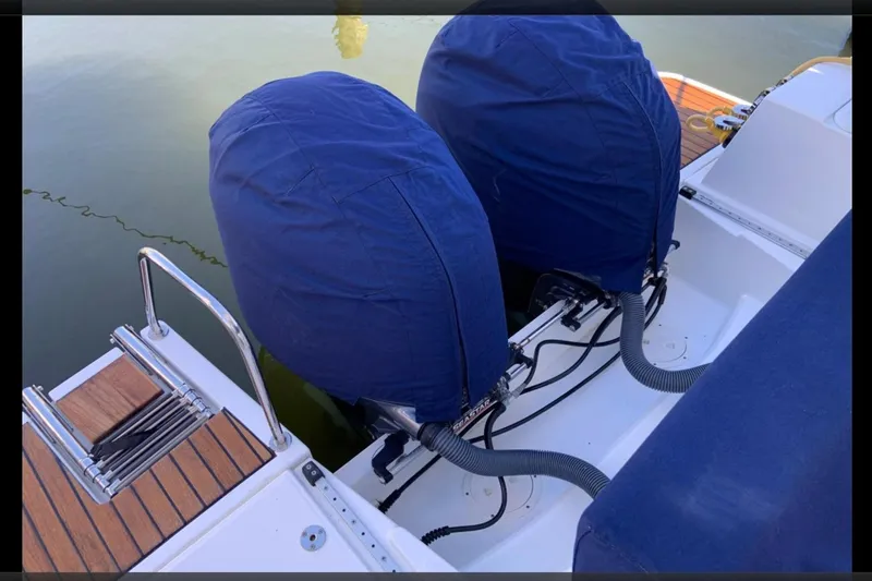 Iffin Yacht Photos Pics 2018 Jeanneau NC 895 boat with covered outboard motors and teak deck.