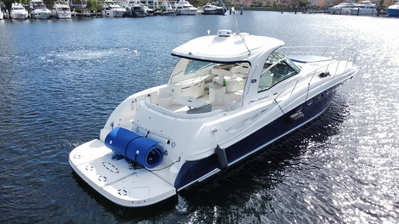  Yacht Photos Pics 2004 Sea Ray 500 Sundancer yacht cruising on a calm marina.