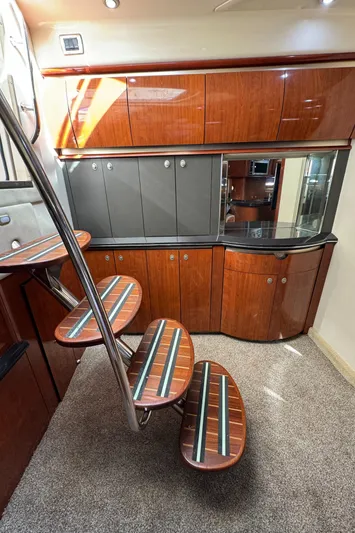  Yacht Photos Pics Interior of 2004 Sea Ray 500 Sundancer yacht with wooden cabinetry and spiral staircase.