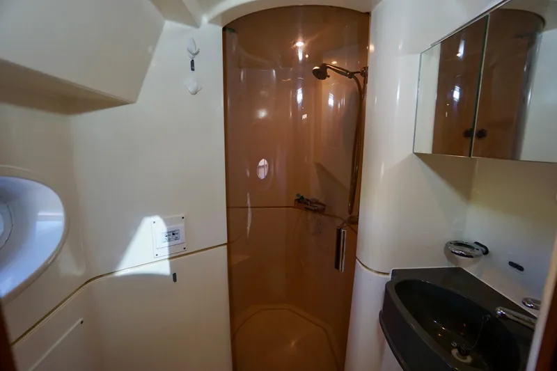 Fifth Day Yacht Photos Pics Bathroom interior of 2000 Venturer 44 yacht with shower and sink.