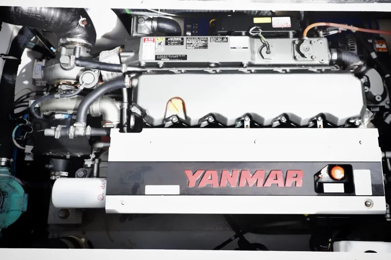 Fifth Day Yacht Photos Pics Yanmar engine in a 2000 Venturer 44 boat, showcasing mechanical components and branding.