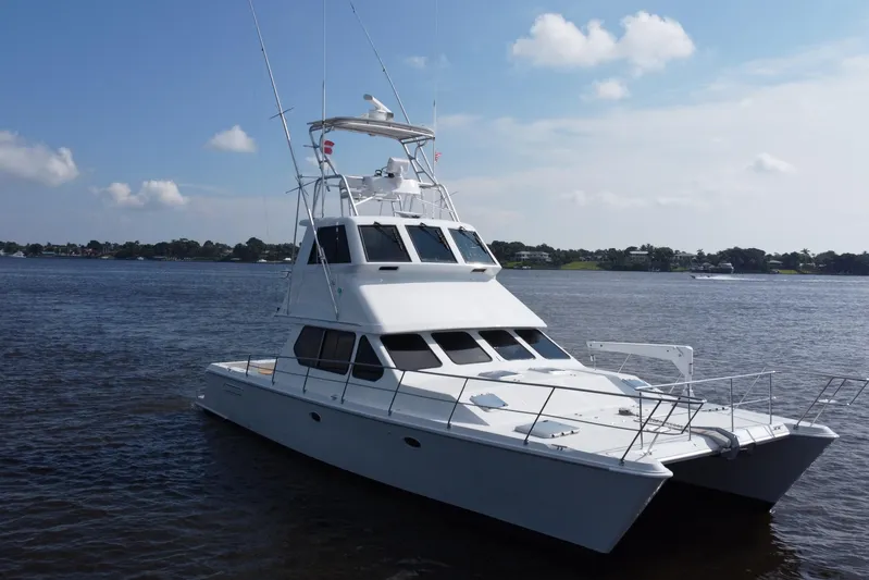 Fifth Day Yacht Photos Pics Voyager 44 yacht from 2000 on calm waters under a clear sky.