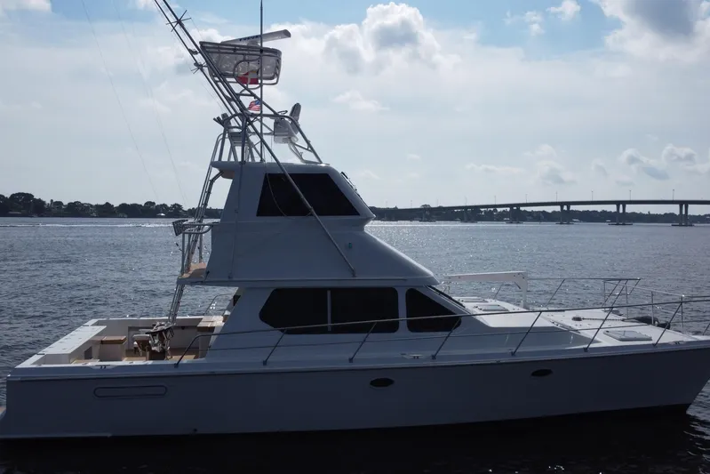 Fifth Day Yacht Photos Pics Voyager 44 yacht from 2000 on calm waters with bridge in background.