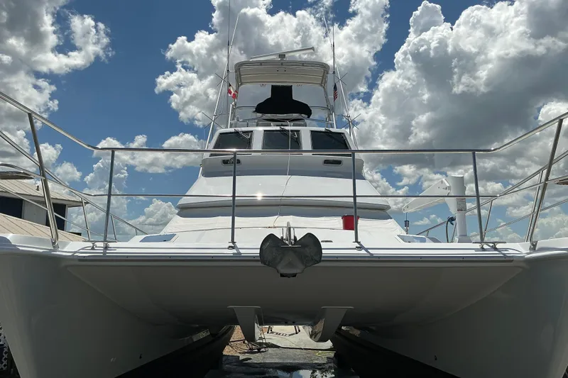 Fifth Day Yacht Photos Pics Voyager 44 yacht from 2000, docked under a partly cloudy sky.