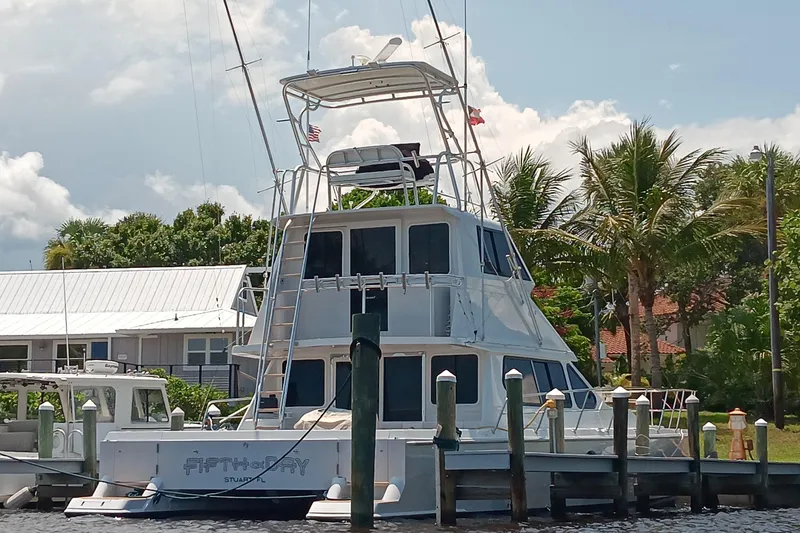 Fifth Day Yacht Photos Pics Voyager 44 yacht docked near palm trees, showcasing sleek design, 2000 model.