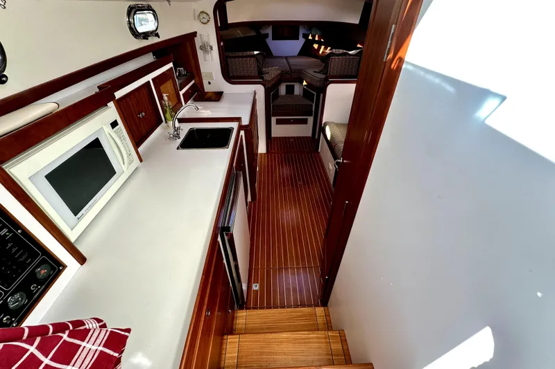 Maestro Yacht Photos Pics Interior of 2006 Lyman-Morse 38 Jet Boat with kitchen and seating area.