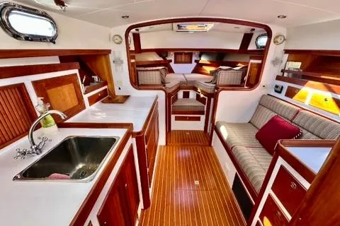 Maestro Yacht Photos Pics Luxurious interior of 2006 Lyman-Morse 38 Jet Boat with wood finish and cozy seating.