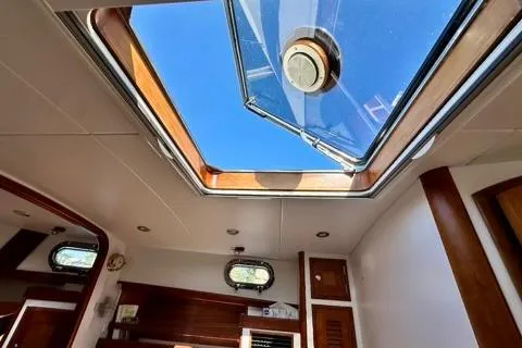 Maestro Yacht Photos Pics Interior view of 2006 Lyman-Morse 38 Jet Boat with skylight and wooden accents.