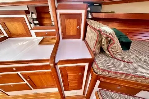 Maestro Yacht Photos Pics 2006 Lyman-Morse 38 Jet Boat interior with wood cabinetry and cushioned seating.