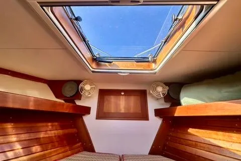 Maestro Yacht Photos Pics Interior cabin of 2006 Lyman-Morse 38 Jet Boat with skylight and wooden finishes.