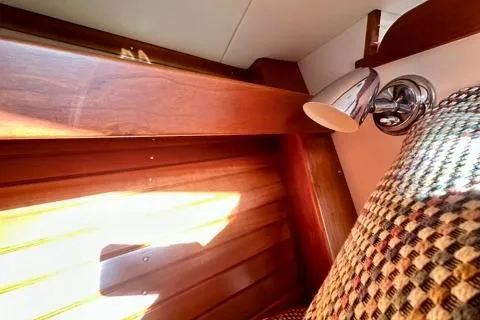 Maestro Yacht Photos Pics Interior of 2006 Lyman-Morse 38 Jet Boat with wood paneling and patterned upholstery.