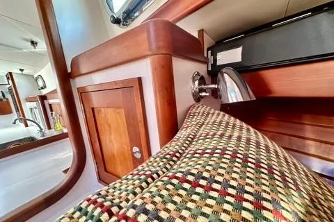 Maestro Yacht Photos Pics Interior of 2006 Lyman-Morse 38 Jet Boat with wood cabinetry and patterned upholstery.