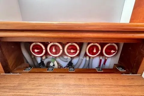 Maestro Yacht Photos Pics Control panel of a 2006 Lyman-Morse 38 Jet Boat with red dials and labeled switches.