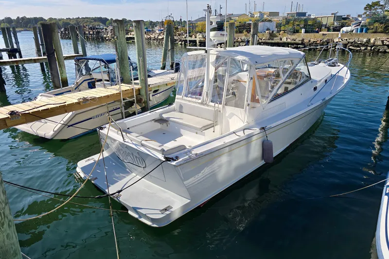 Maestro Yacht Photos Pics 2006 Lyman-Morse 38 Jet Boat docked in a marina, clear day.