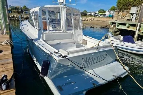Maestro Yacht Photos Pics 2006 Lyman-Morse 38 Jet Boat docked in a sunny marina.