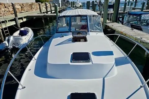 Maestro Yacht Photos Pics 2006 Lyman-Morse 38 Jet Boat docked at a marina, showcasing sleek design and spacious deck.