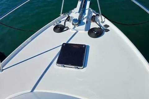 Maestro Yacht Photos Pics 2006 Lyman-Morse 38 Jet Boat bow with hatch and railing on calm water.