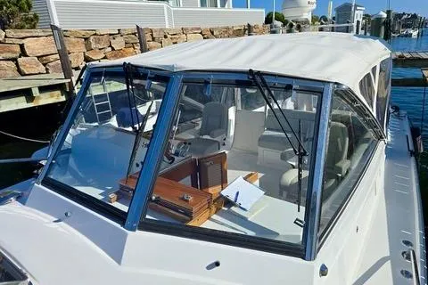 Maestro Yacht Photos Pics 2006 Lyman-Morse 38 Jet Boat with covered cockpit and modern design at a dock.