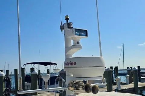 Maestro Yacht Photos Pics 2006 Lyman-Morse 38 Jet Boat docked with marine equipment under clear blue sky.