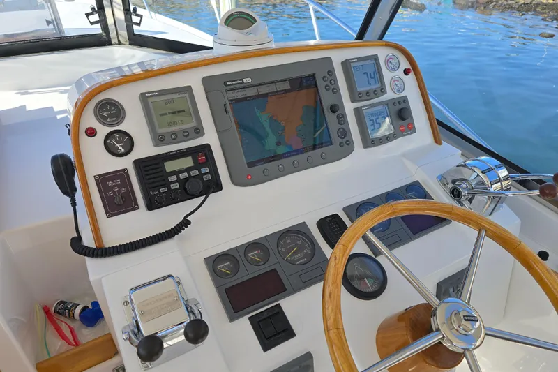 Maestro Yacht Photos Pics Helm of 2006 Lyman-Morse Monhegan 38 Twin Jet with navigation instruments and wooden steering wheel.