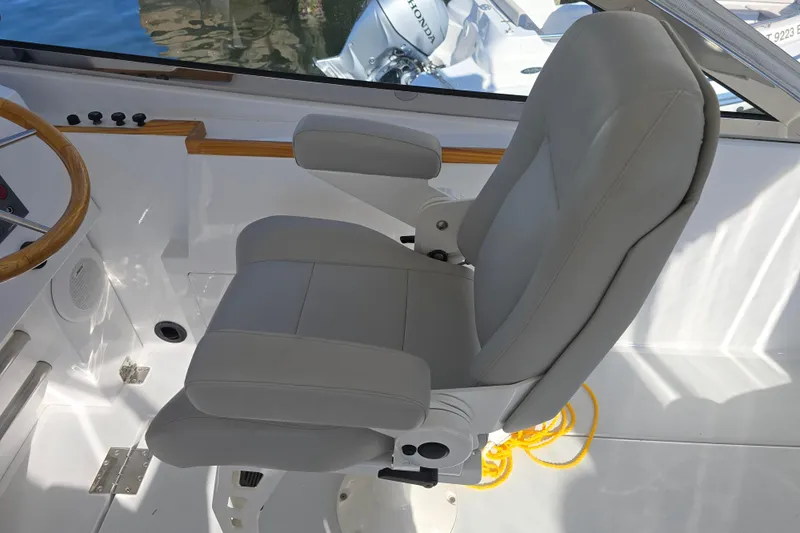 Maestro Yacht Photos Pics Captain's chair on 2006 Lyman-Morse Monhegan 38 Twin Jet boat, featuring sleek design.