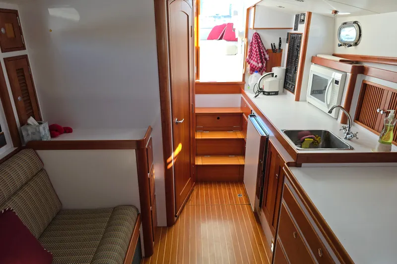 Maestro Yacht Photos Pics Luxurious 2006 Lyman-Morse Monhegan 38 yacht interior with kitchenette and seating area.