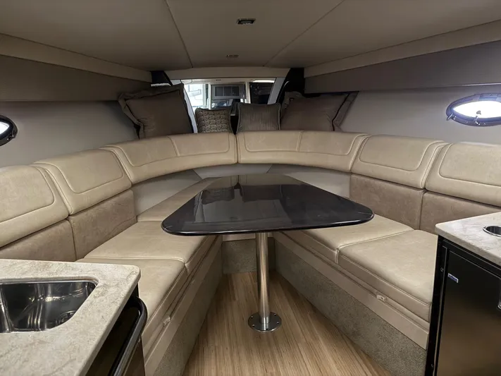  Yacht Photos Pics 2014 Formula 350 Sun Sport cabin interior with beige seating and a central table.