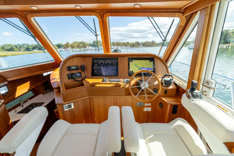  Yacht Photos Pics 2022 Sabre 48 Salon Express helm with modern navigation equipment and luxurious seating.