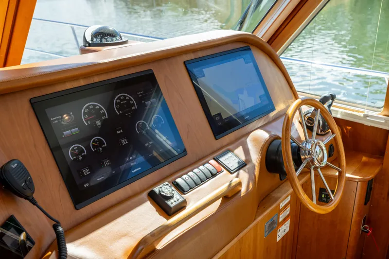  Yacht Photos Pics 2022 Sabre 48 Salon Express helm with dual screens and wooden steering wheel.