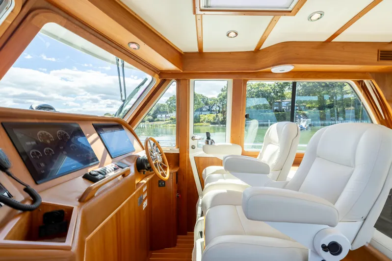  Yacht Photos Pics Interior of 2022 Sabre 48 Salon Express yacht with luxurious seating and navigation controls.