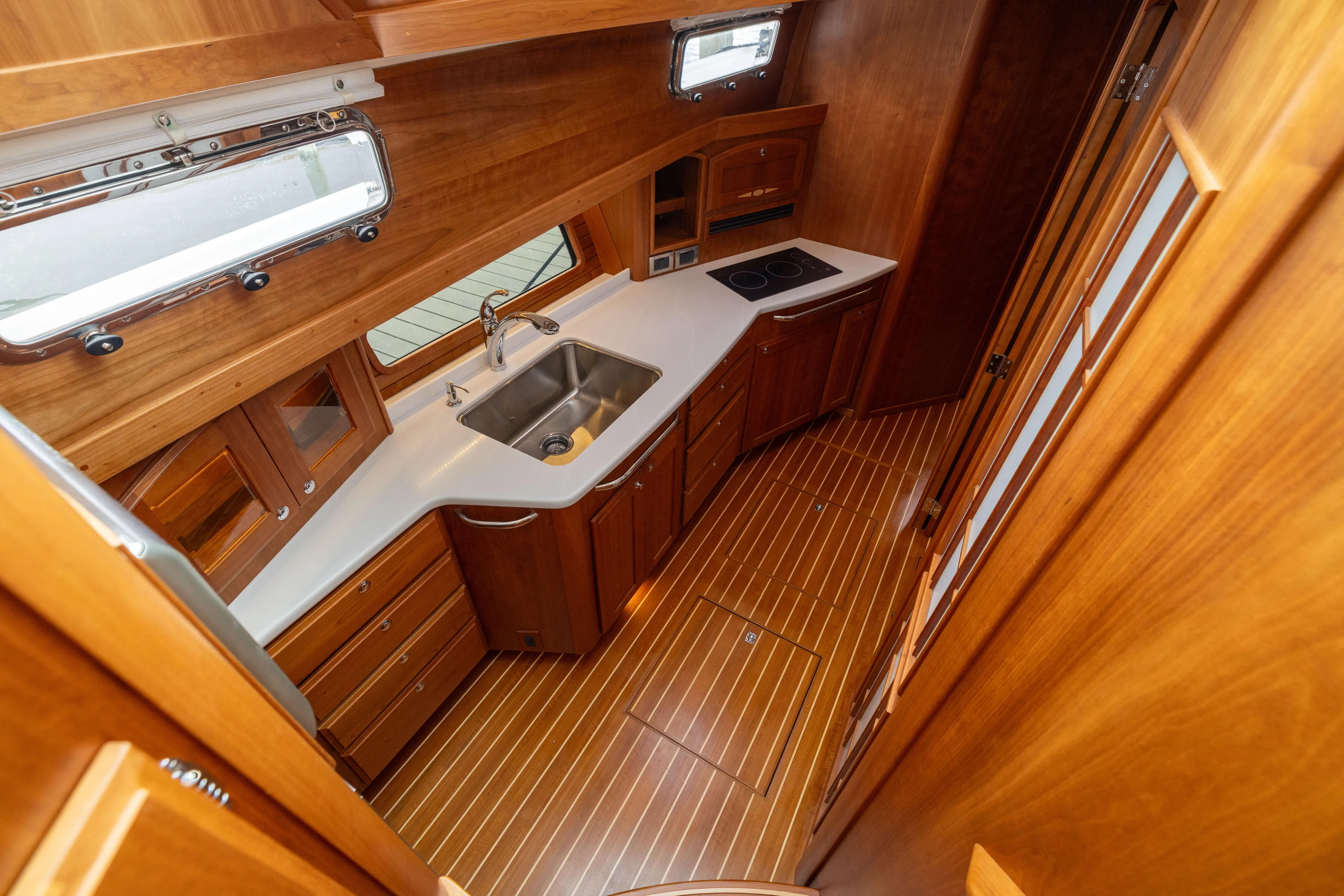  Yacht Photos Pics Luxurious 2022 Sabre 48 Salon Express yacht interior with elegant wood cabinetry and modern kitchen amenities.