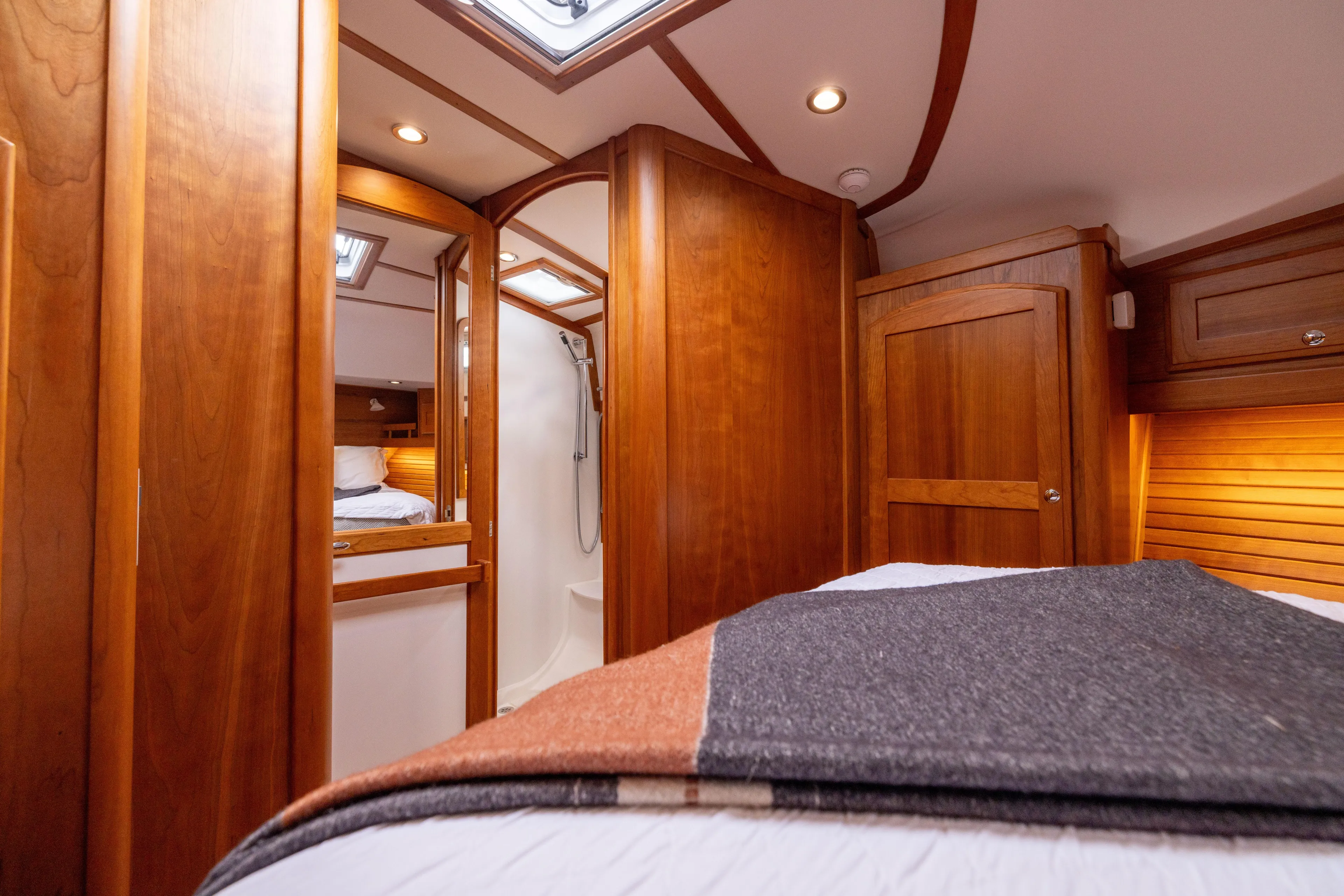  Yacht Photos Pics Interior of 2022 Sabre 48 Salon Express yacht, featuring elegant wood finishes and cozy cabin.
