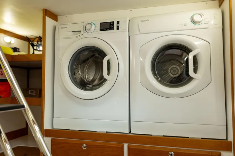  Yacht Photos Pics Laundry appliances inside 2022 Sabre 48 Salon Express yacht interior.