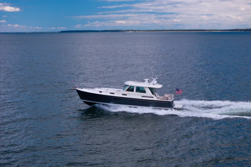  Yacht Photos Pics 2022 Sabre 48 Salon Express cruising on open water under a clear sky.