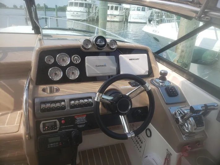  Yacht Photos Pics Cockpit of 2014 Formula 350 Sun Sport boat with steering wheel and navigation instruments.